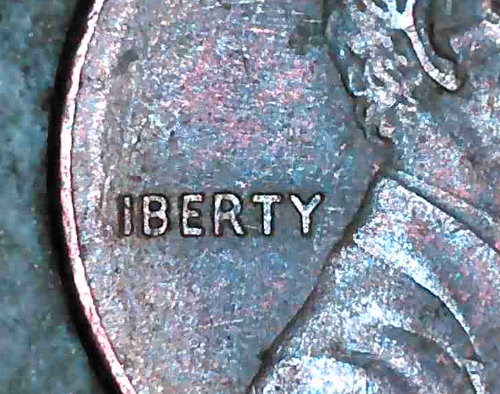 Close-up of a Lincoln cent with the word LIBERTY missing the letter L, showing as “IBERTY.”