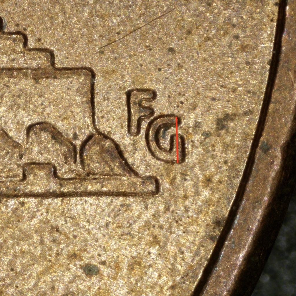 Close-up of the weak FG initials on a Close AM Lincoln cent. The G lacks the strong serif found on Wide AM reverses, highlighted here with a vertical reference line.