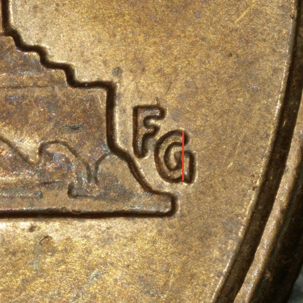 Close-up of the FG designer initials on a 2000 Wide AM Lincoln cent, showing the strong FG style. The G has a clear serif on the lower right, highlighted by a vertical reference line.
