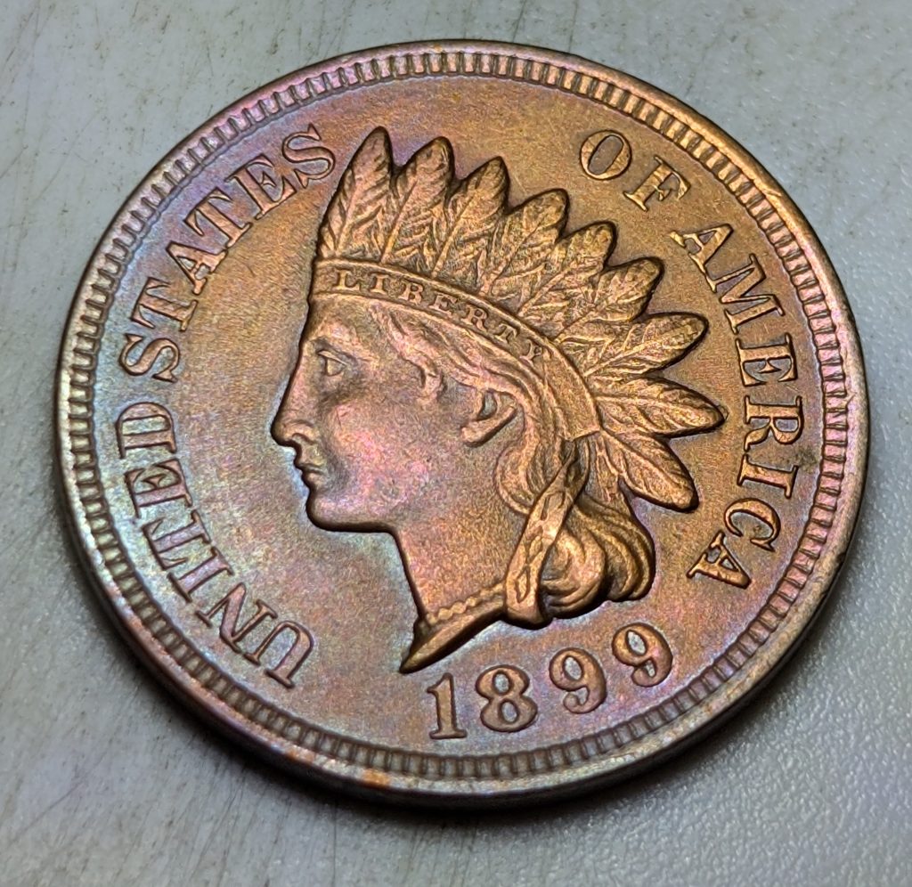An 1899 Indian Head cent with sharp, well-defined details and strong luster, showing a clear example of a strong strike.