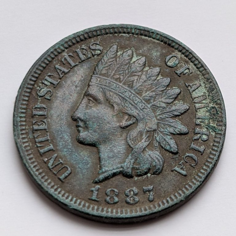 1887 Indian Head cent with advanced verdigris. A perfect example of how copper reacts to decades of moisture and air exposure.