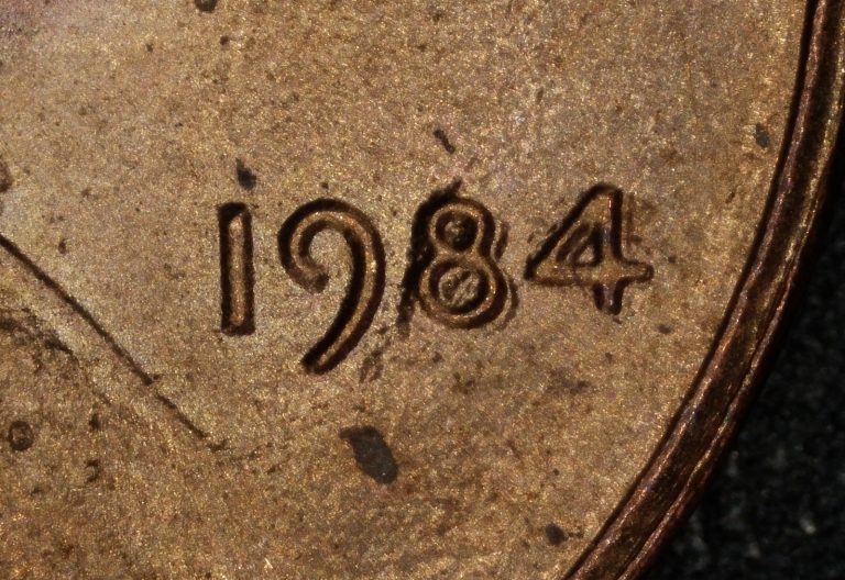 Close-up of the 1984 date on a Lincoln cent showing machine doubling with a false interior bar in the 4 and outline doubling on the 8