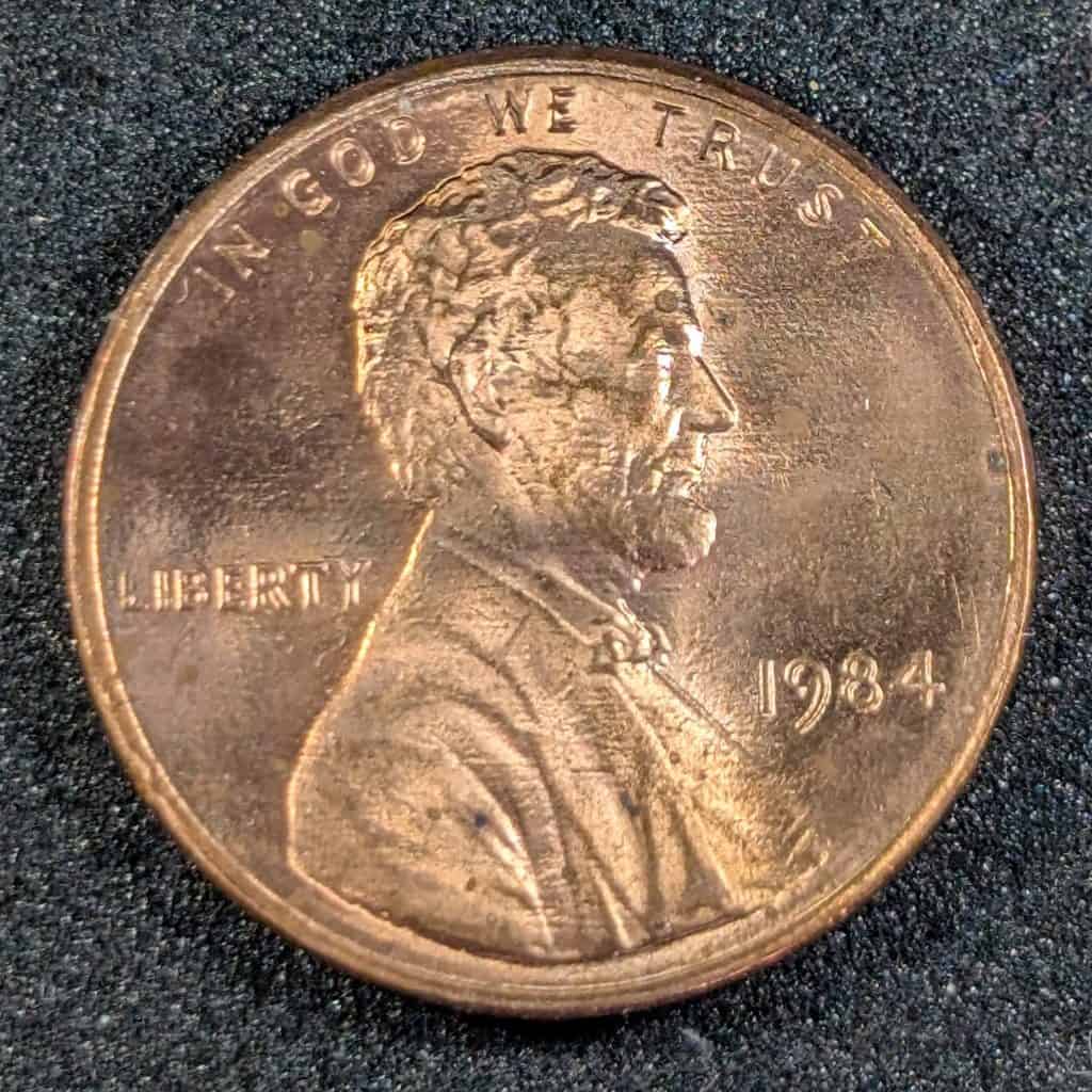 1984 Lincoln cent obverse showing strong machine doubling on the date, with shelf-like doubling visible under direct lighting