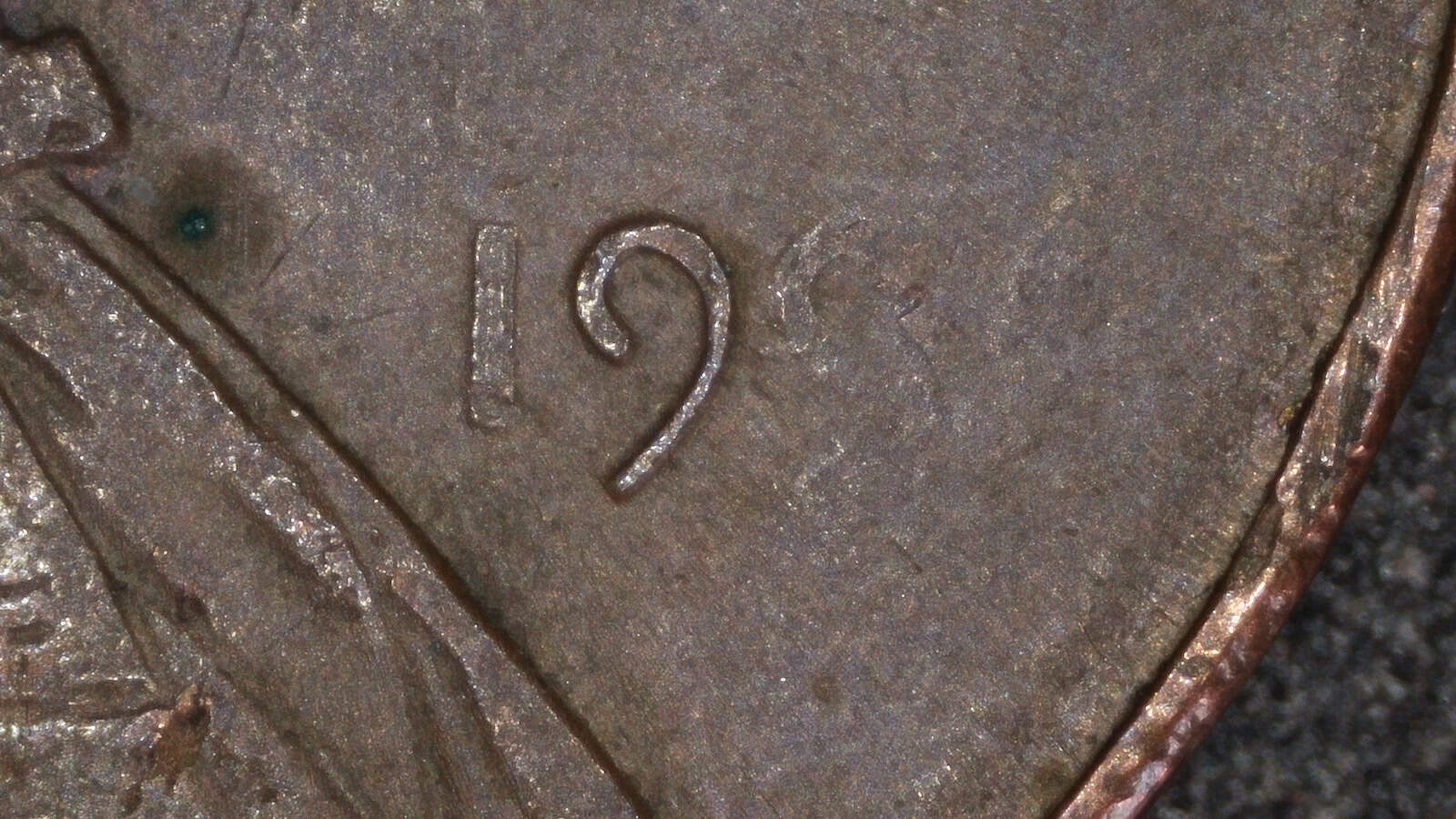 Close-up of the date area on a 1996 Lincoln cent showing a weak and partially missing date caused by a grease-filled die.