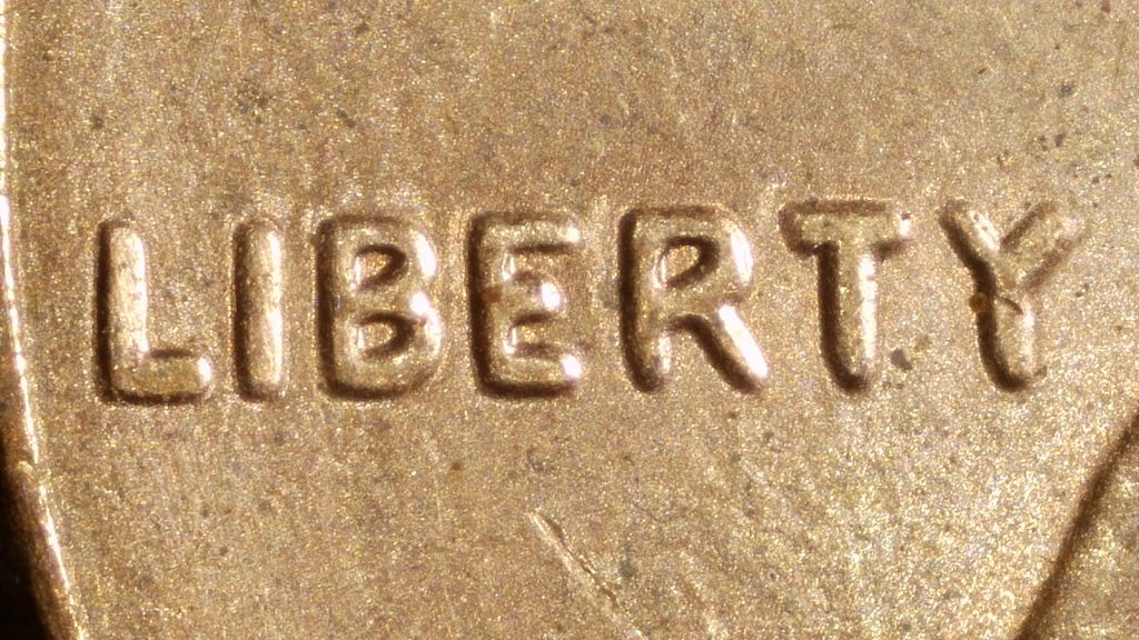 Close-up of the word LIBERTY on a 2019 Lincoln cent showing rounded, thickened letters consistent with a doubled die obverse.